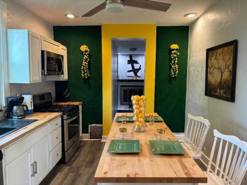 eine Küche mit einem Holztisch und grünen Wänden in der Unterkunft Wellness Oasis Near Downtown Pittsburgh in Pittsburgh