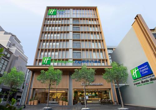 a tall building with a sign on the front of it at Holiday Inn Express & Suites Bangkok Central Pier by IHG in Bangkok