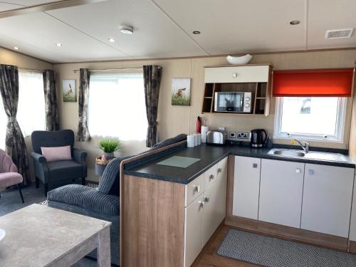 a kitchen and living room in a caravan at 3 bedroom caravan on luxury Devon Holiday Park in Paignton