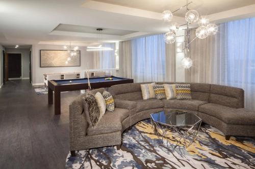 a living room with a couch and a pool table at Dallas/Fort Worth Airport Marriott in Irving