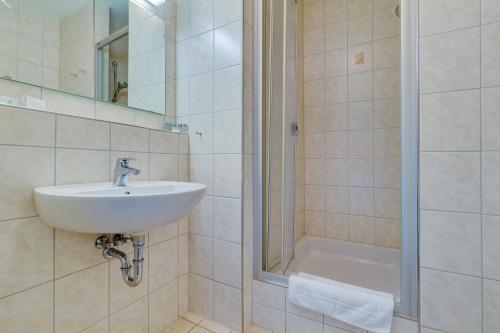 a bathroom with a sink and a shower at Panorama Ferien Hotel Harz in Güntersberge