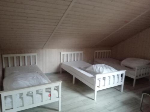two beds in a room with a roof at Ferienhaus Büffel mit Sauna in Twist in Twist