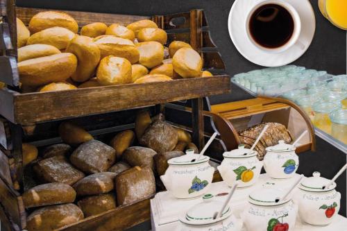a table filled with lots of bread and cups of coffee at Hotel Jagdschloss Letzlingen in Letzlingen
