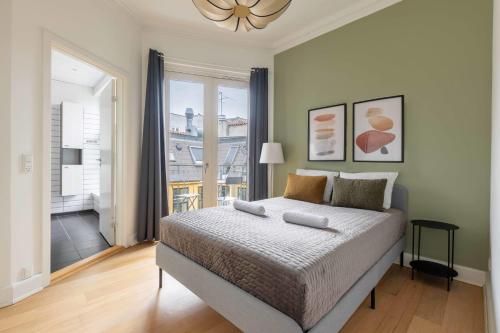 a bedroom with a bed and a large window at Apartment with Private Balcony in central Copenhagen City in Copenhagen