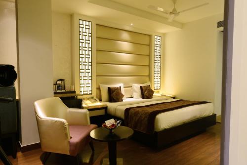 a hotel room with a bed and a chair at Hotel City Star - Free Airport Pickup in New Delhi