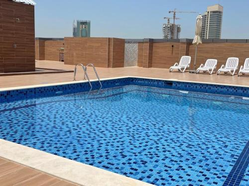 a swimming pool on the roof of a building at Stay in the heart of Sport City in LUX 1BDR with sky view 11 in Dubai