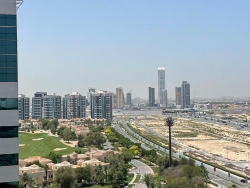 a city skyline with tall buildings and a freeway at Stay in the heart of Sport City in LUX 1BDR with sky view 11 in Dubai