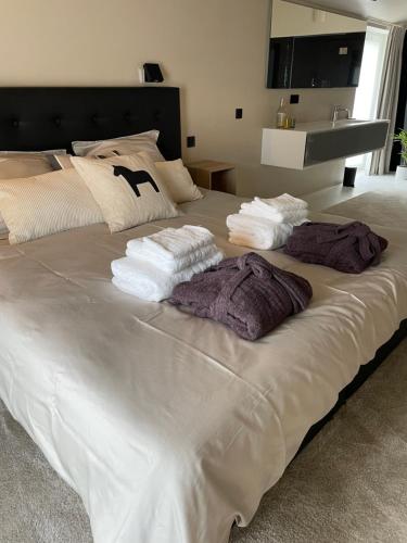 a large white bed with towels on top of it at Suite & Vins - Gîte d’exception in Namur