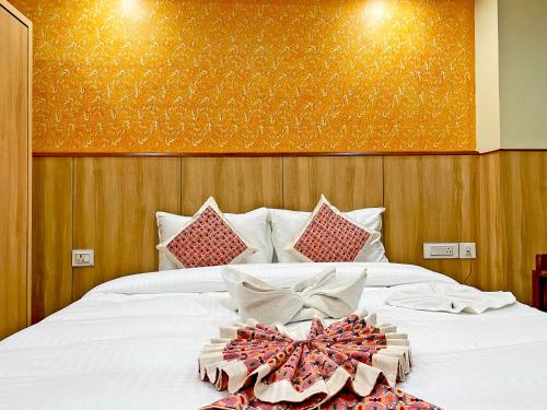 a bedroom with a bed with a bow on it at Hotel Lumbini Airport in Kathmandu