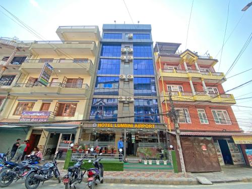 a tall building with motorcycles parked in front of it at Hotel Lumbini Airport in Kathmandu