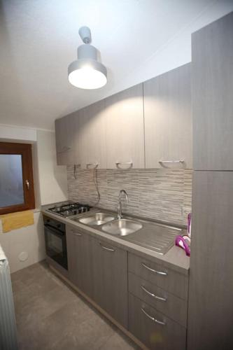 a kitchen with a sink and a stove at Casa Vacanze Da Pietro in Gangi