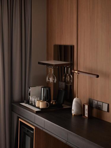 a kitchen with a counter top with a coffee maker at Amara Singapore in Singapore