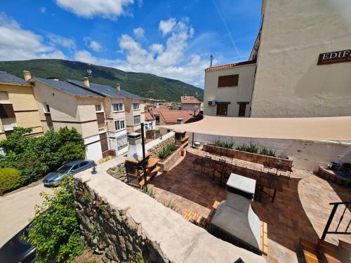 a balcony of a building with a table and benches at Casa Rural TioMoreno by Naturadrada in La Adrada