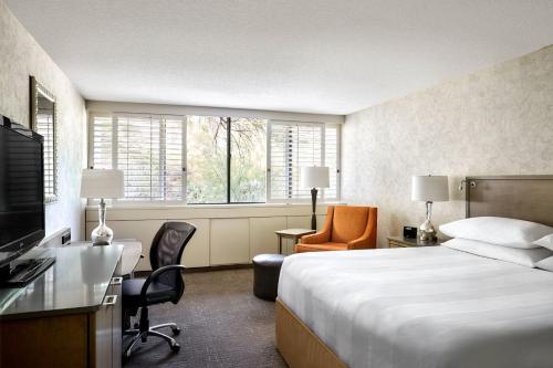 a hotel room with a bed and a desk at Phoenix Marriott Resort Tempe at The Buttes in Tempe