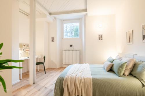 ein weißes Schlafzimmer mit einem Bett und einem Fenster in der Unterkunft Fortezza Apartment in Florence in Florenz