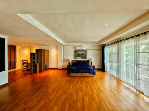um quarto grande com uma cama e uma janela grande em Alpine Mansion em Ban Huai Sai Nua