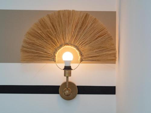 a light fixture with a fan on a wall at Sibs Sanlúcar Atlantico Playa Vistas Reformado in Sanlúcar de Barrameda