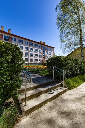 a building with stairs in front of a building at Kreutzwaldi 17 apartment in Võru