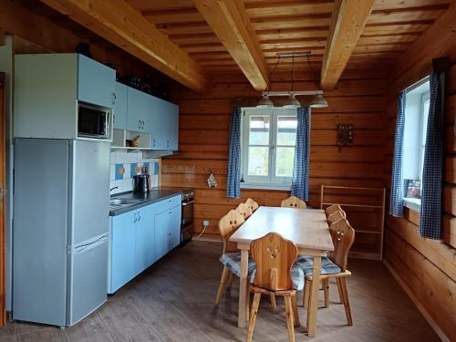 een keuken met een tafel en stoelen in een huisje bij Chalupa Jadrná 2 in Orlické Záhoří 