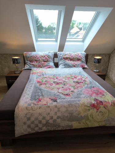 a bedroom with a large bed with flowers on it at Ubytování U Janča in Lednice