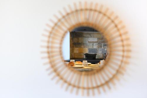 a mirror with a reflection of a table with food at Côté Sud in Palavas-les-Flots
