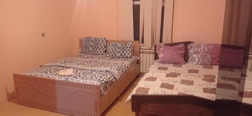 a bedroom with two beds with pillows on them at Sərin göl istirahət mərkəzi in Quba