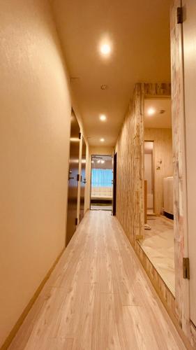 a hallway of a house with a wooden floor at 幸 in Osaka