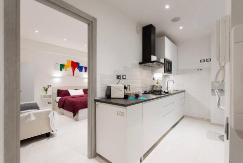 a white kitchen with a sink and a room at RomeEyes2020 in Rome