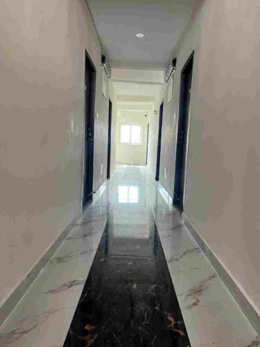 a corridor of a building with water in the floor at Stay In Hotels and Resorts in Hyderabad