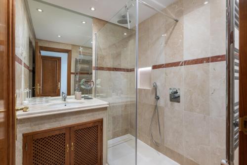 y baño con ducha y lavamanos. en Costalita Beach Apartment, en Estepona