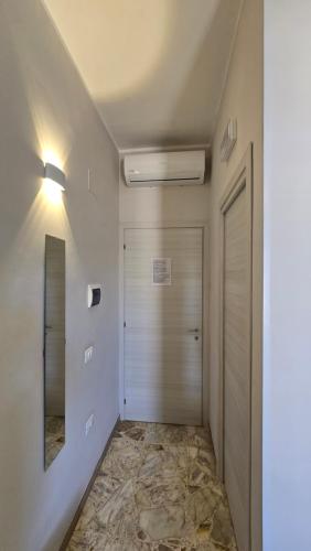 a hallway with a door and a mirror at AD UN PASSO DAL MARE in Praia a Mare