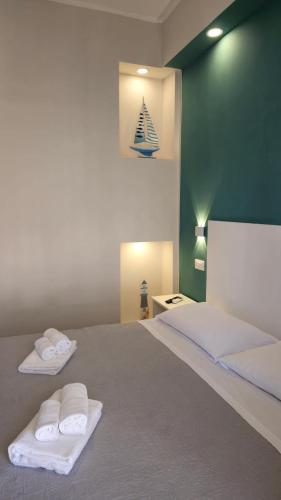 a bedroom with a large bed with towels on it at AD UN PASSO DAL MARE in Praia a Mare