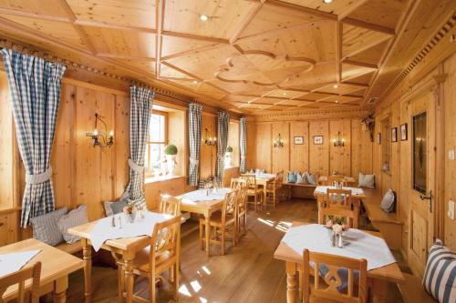 a restaurant with wooden walls and tables and chairs at Hotel Obermaier in Munich
