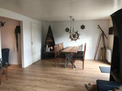 - une salle à manger avec une table et des chaises en bois dans l'établissement Super Nice House In The Harbor Town Of Hvalpsund,, à Farsø