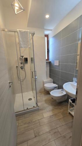 a bathroom with a shower and a toilet and a sink at AD UN PASSO DAL MARE in Praia a Mare