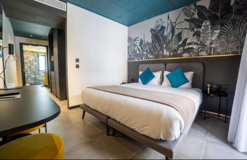 a bedroom with a large bed and a table and a desk at Eleven by Warren Collection in Sliema