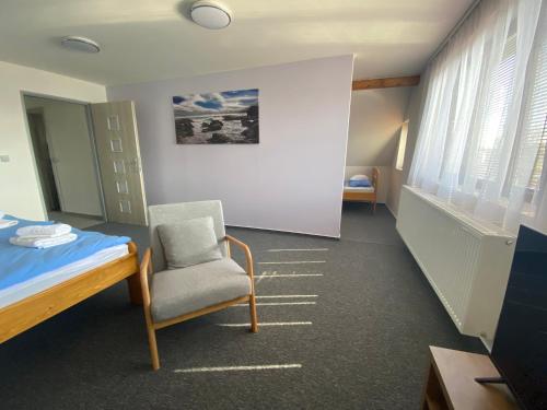 a hospital room with a bed and a chair at Apartmány U Jeřábků in Rapotín