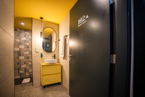 a bathroom with a sink and a mirror at Eleven by Warren Collection in Sliema