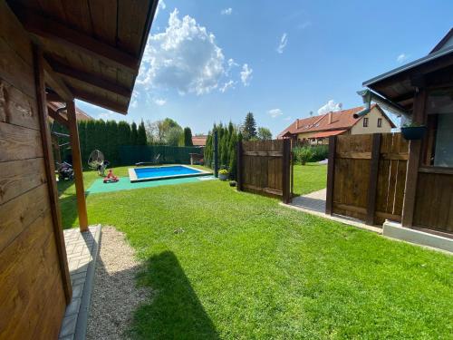 a backyard with a fence and a swimming pool at Apartmány U Jeřábků in Rapotín