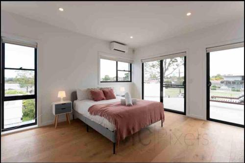 a bedroom with a bed with a laptop on it at Sunset Bay#5 bed Family house Sailing Panorama in Sydney