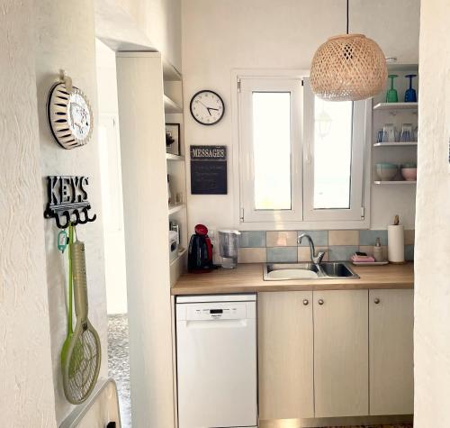 a kitchen with a sink and a window at Socratous House in Salamina