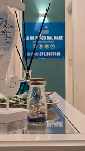 a glass jar with rocks in it on a table at AD UN PASSO DAL MARE in Praia a Mare