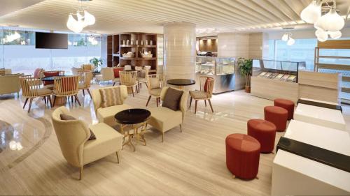 a restaurant with tables and chairs in a room at Crowne Plaza Dhaka Gulshan by IHG in Dhaka