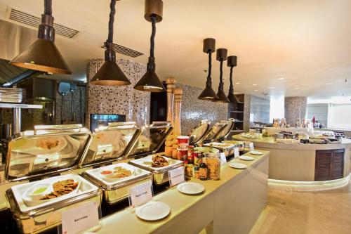 a buffet line with food on display in a restaurant at Crowne Plaza Dhaka Gulshan by IHG in Dhaka