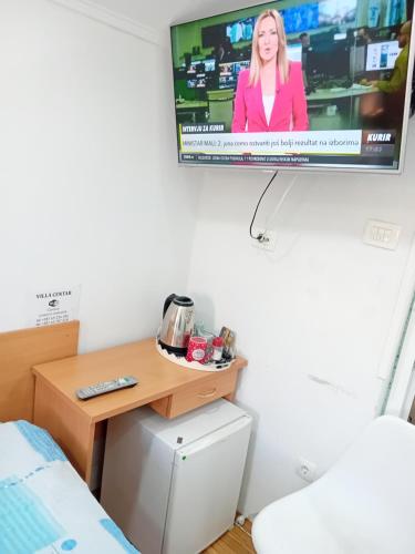 a tv hanging on a wall in a bedroom at Vila Centar in Trebinje
