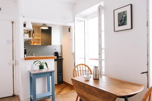une petite cuisine avec une table en bois dans une pièce dans l'établissement Charming studio in Paris near the Eiffel Tower, à Paris