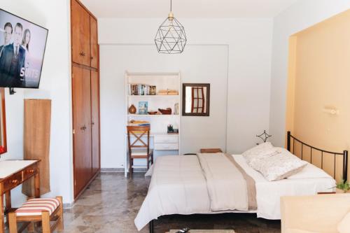 a bedroom with a bed and a desk at 3 Venti - Ostria in Liapades