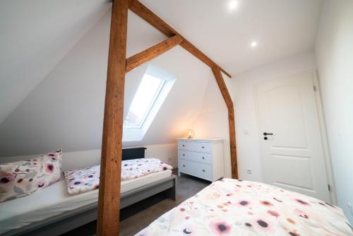a attic bedroom with a bed and a window at Ferienwohnung am Großen Garten Dresden in Dresden