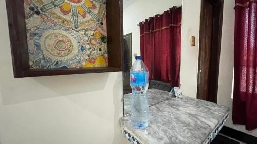 a bottle of water sitting on top of a table at Red Rose Hotel in Bālākot
