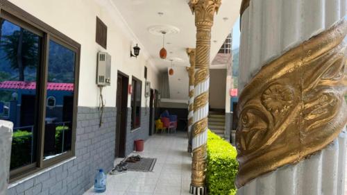 a gold pole on the side of a building at Red Rose Hotel in Bālākot